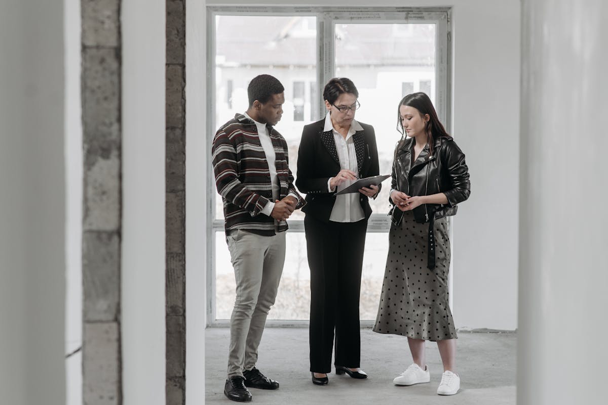A property agent walking buyers through a unit, illustrating the kind of client conversations Singapore agents track on WhatsApp