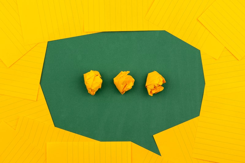 Speech bubble with crumpled paper messages, representing the volume of WhatsApp conversations a Singapore property agent juggles