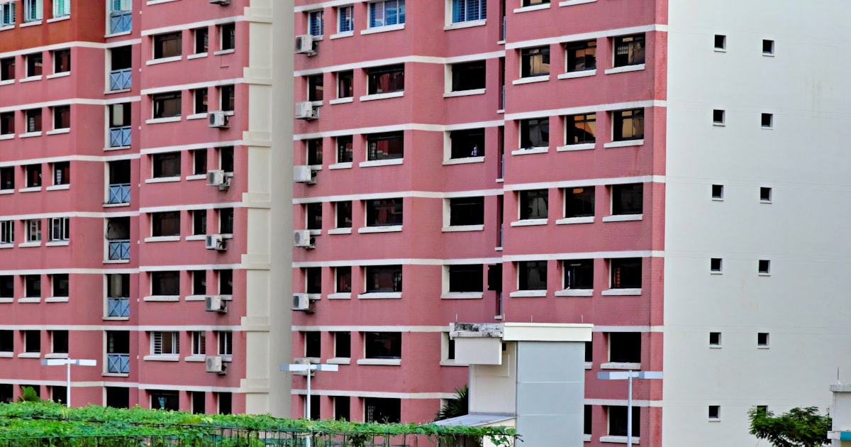 Pink HDB residential block in Singapore, representing the 13,480 flats reaching MOP in 2026
