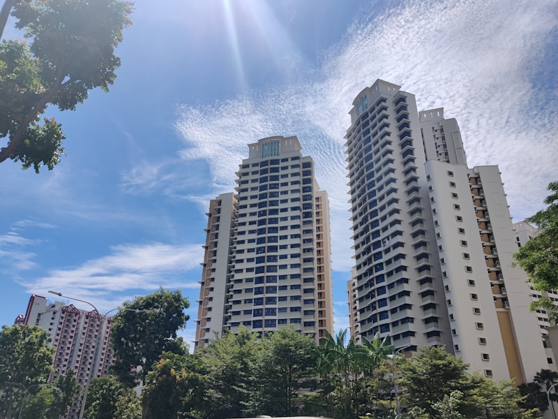 Aerial view of Singapore residential neighbourhood with green trees surrounding HDB blocks