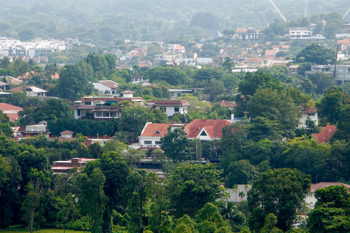 Aerial view of Singapore landed property estate with bungalows and detached houses among tropical greenery