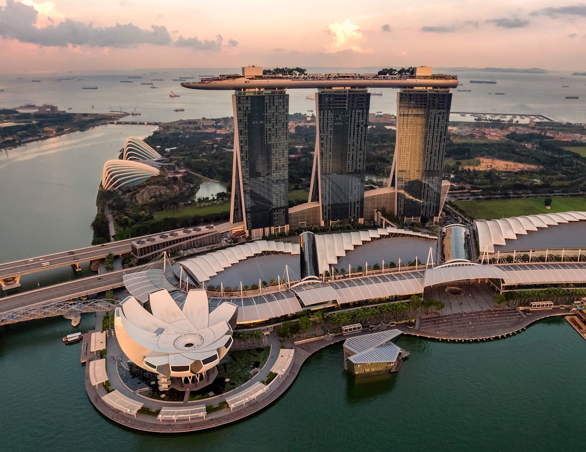 Aerial bird's eye view of Singapore Marina Bay Sands and CBD skyline at sunset