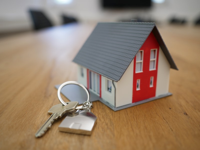 House miniature with keys on a table representing property purchase decisions in a low SORA rate environment